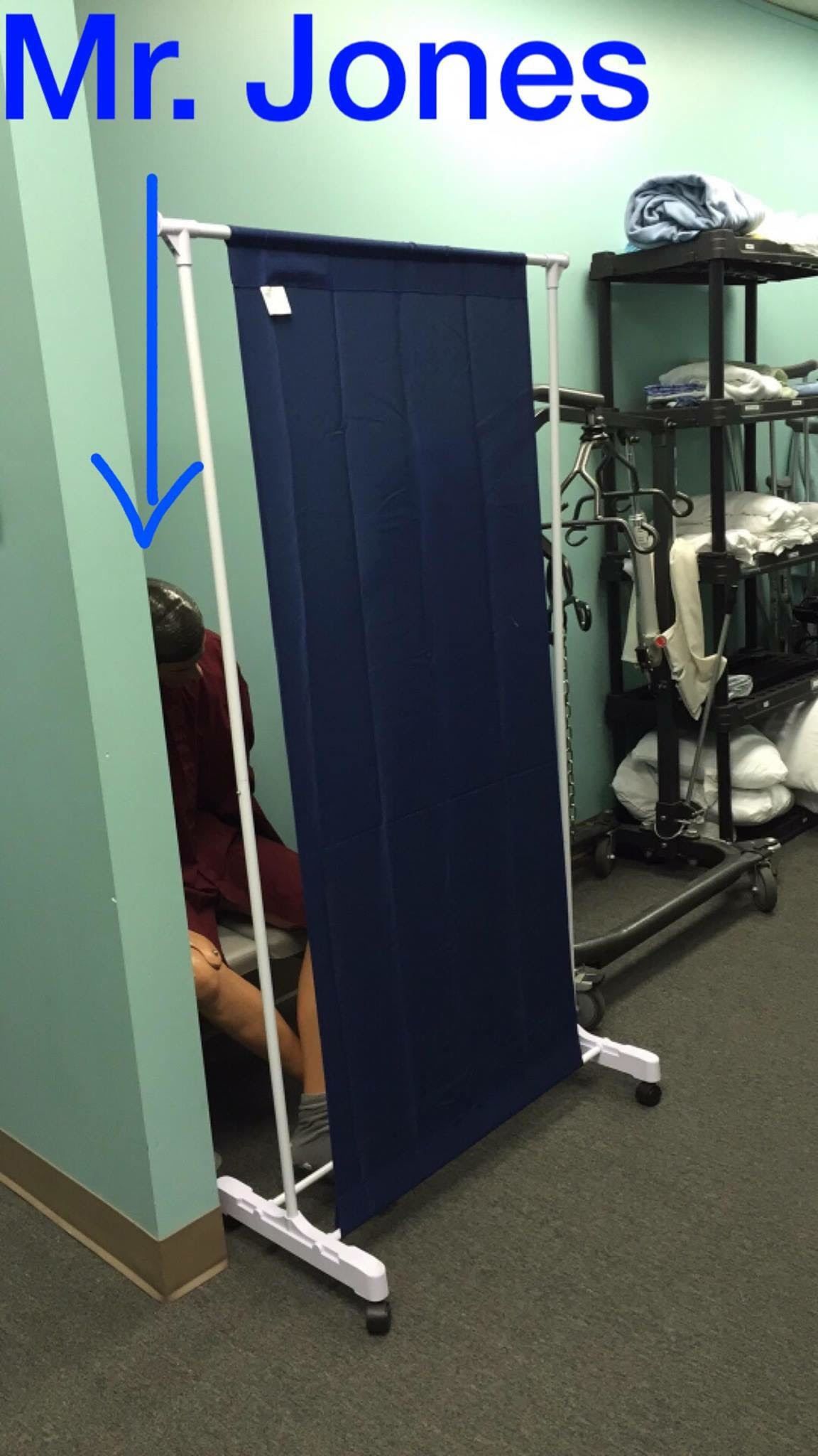 A Person is Hiding Behind a Blue Curtain With the Name Mr. Jones Above It