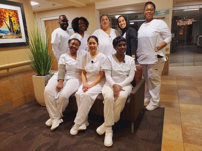 Group of Nurses Are Posing for a Picture While Sitting on a Couch
