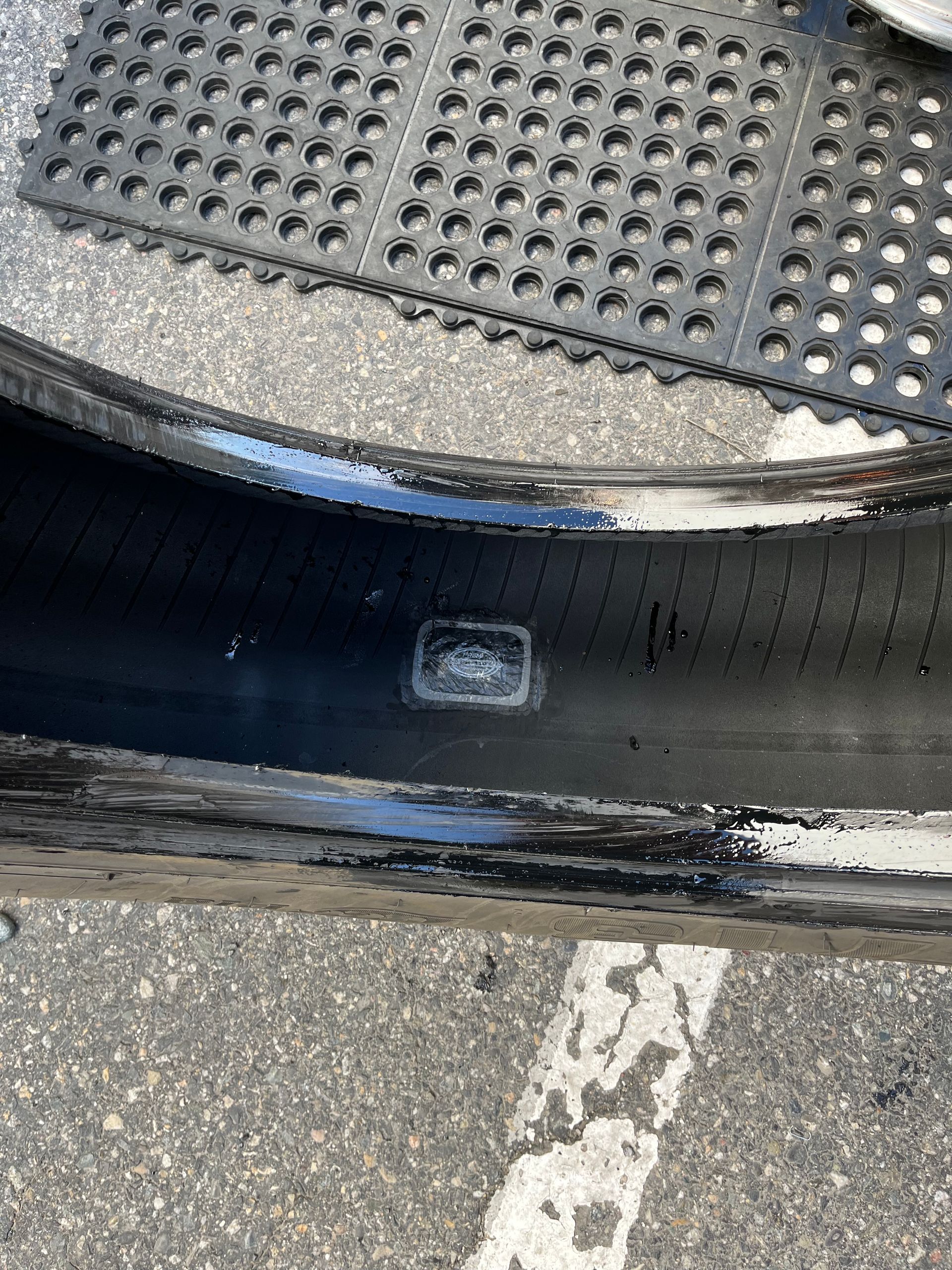 A close up of a tire with a patch on it.