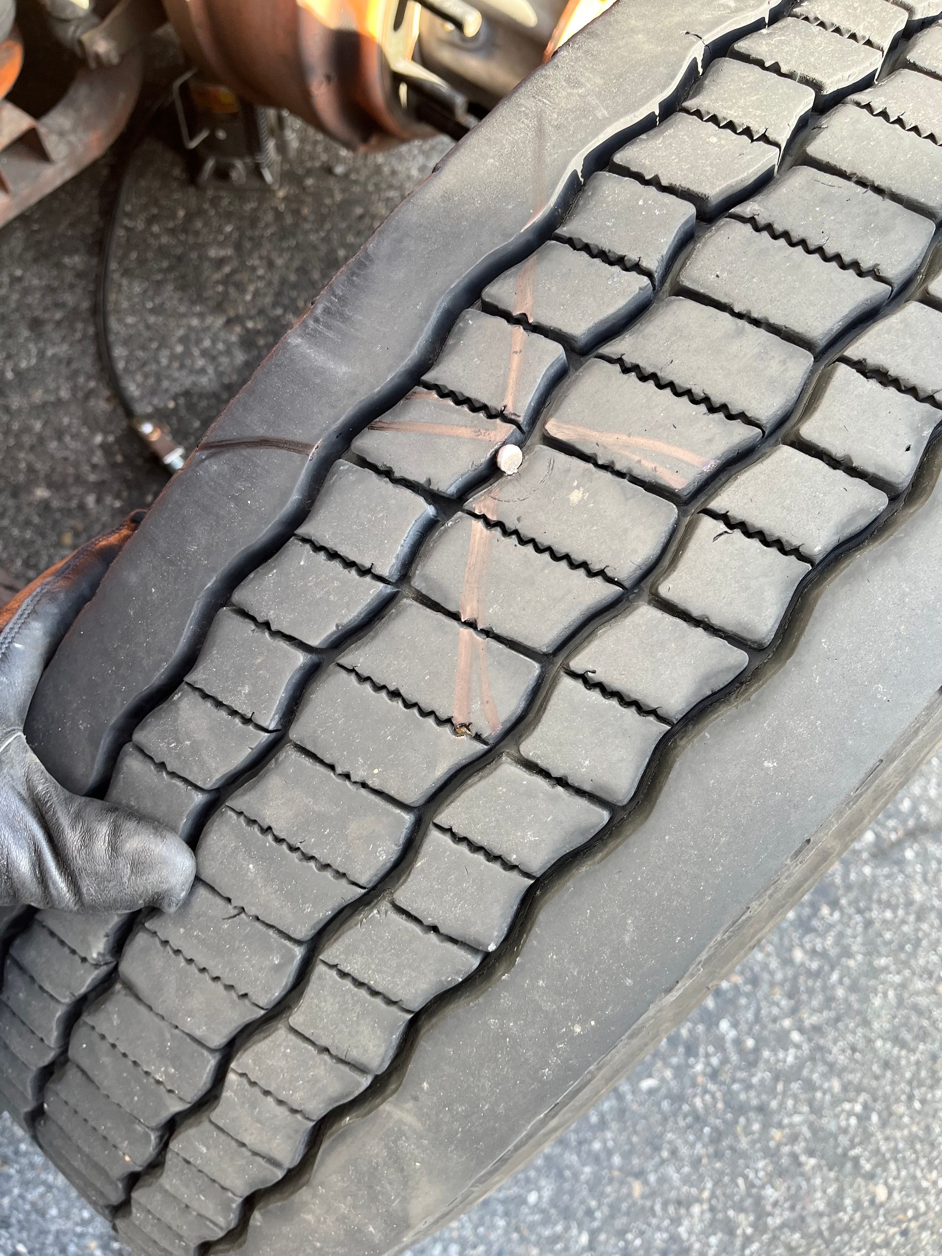 A close up of a tire with a hole in it