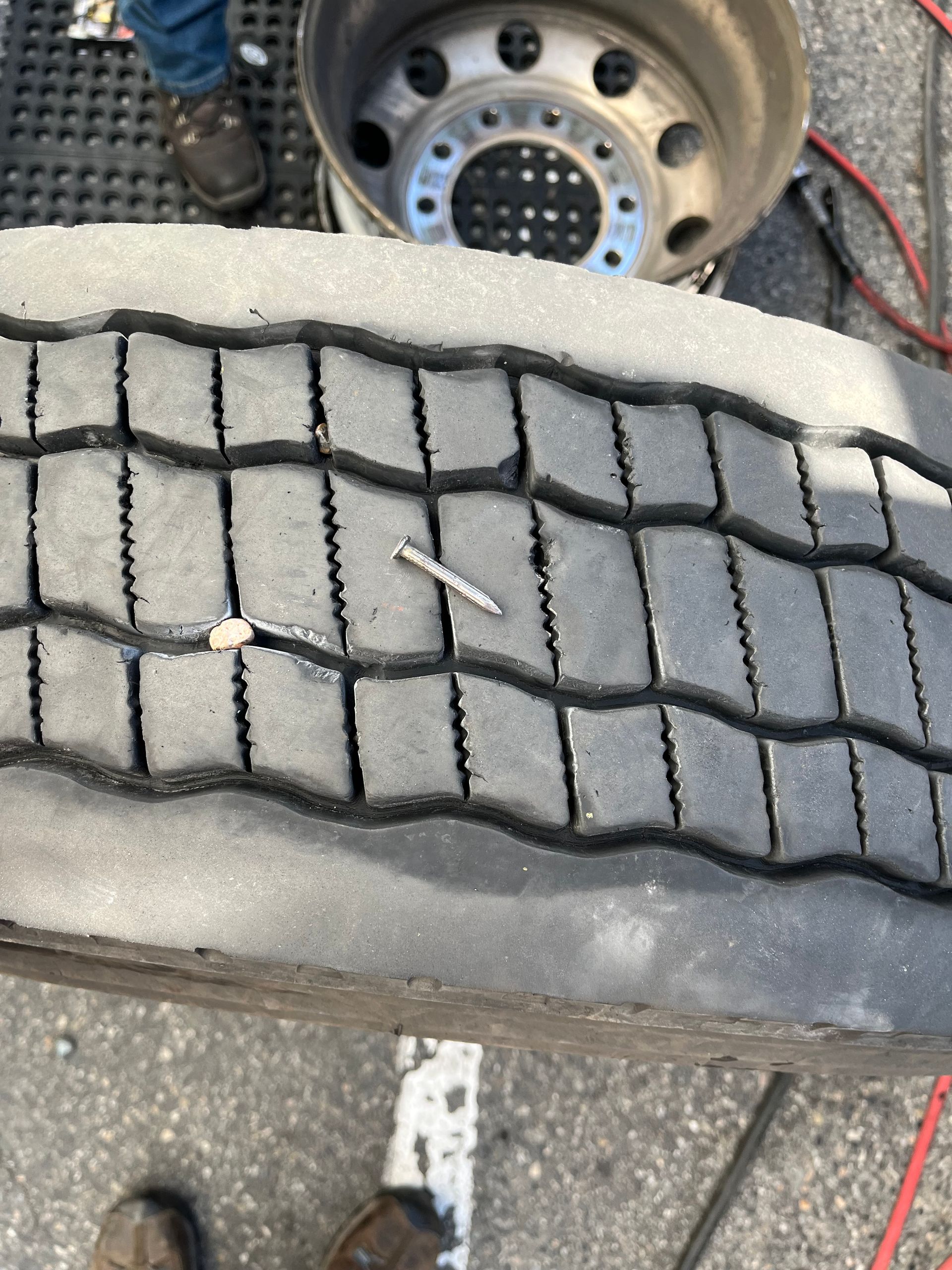 A close up of a tire with a screw in it