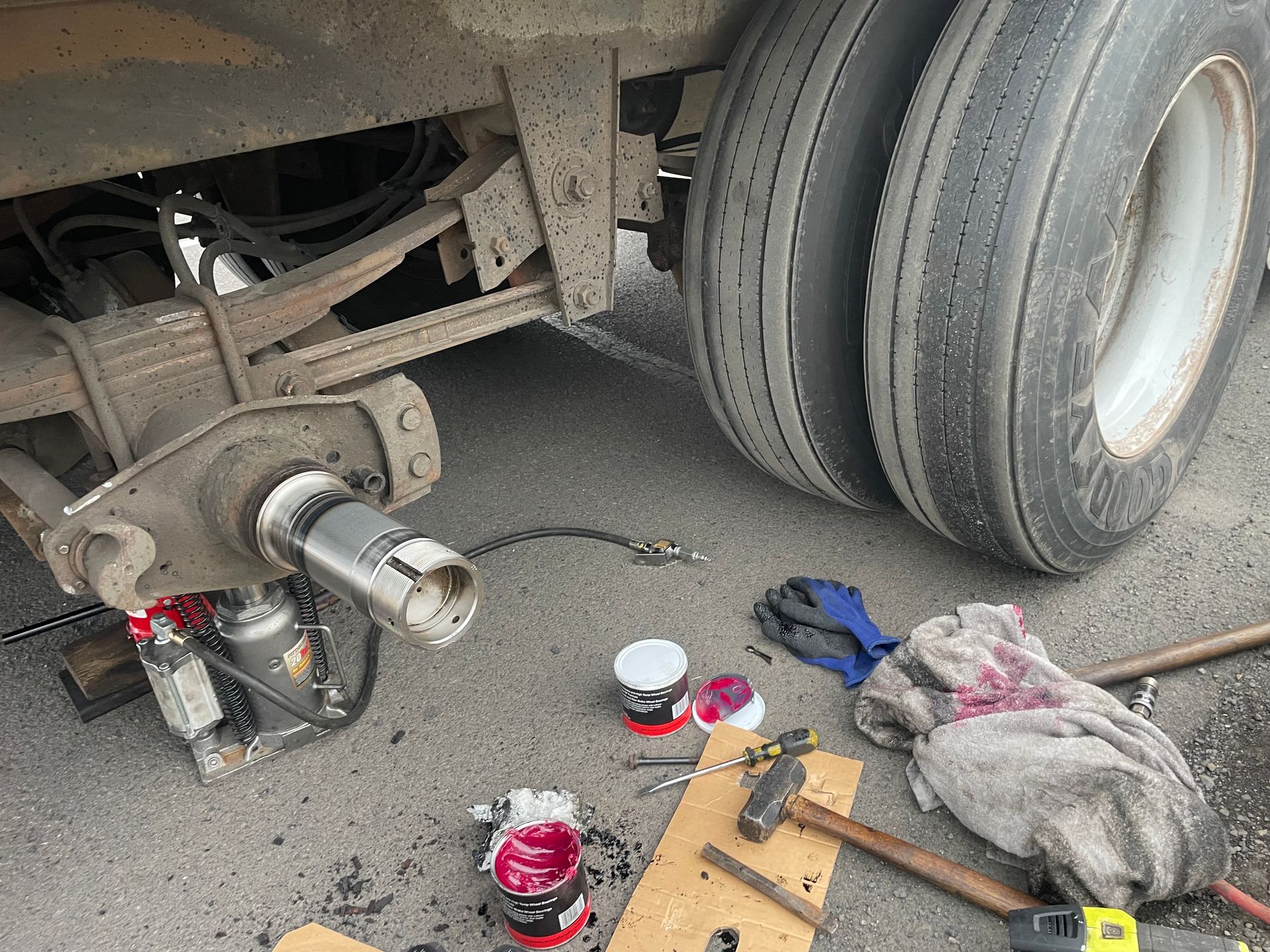 A truck is being repaired on the side of the road.