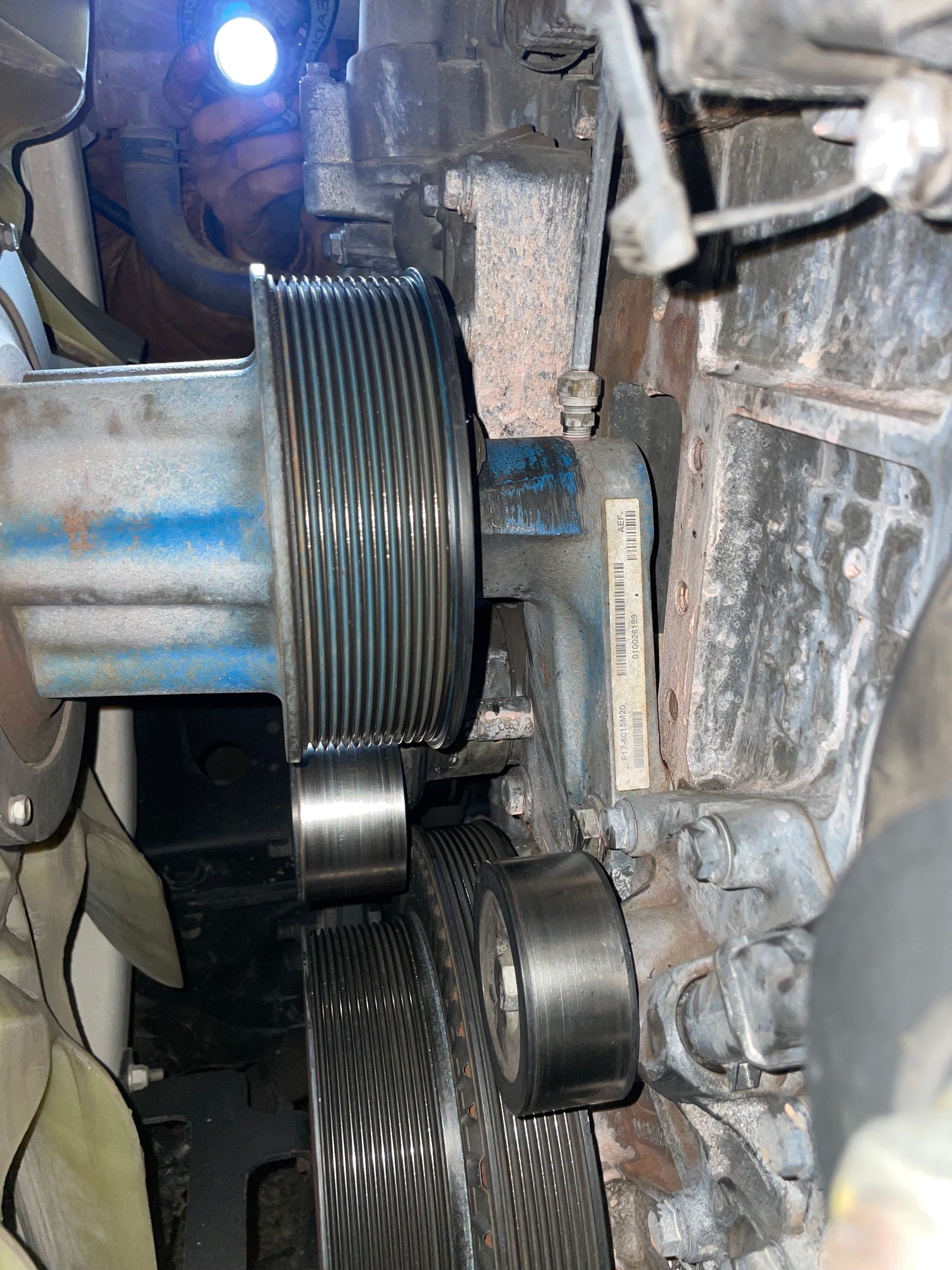 A close up of a belt on a machine with a light on it.