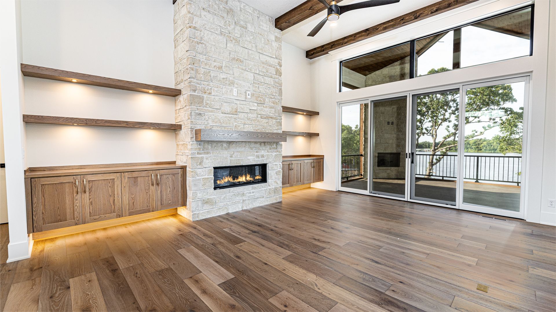 A living room with a fireplace and sliding glass doors.