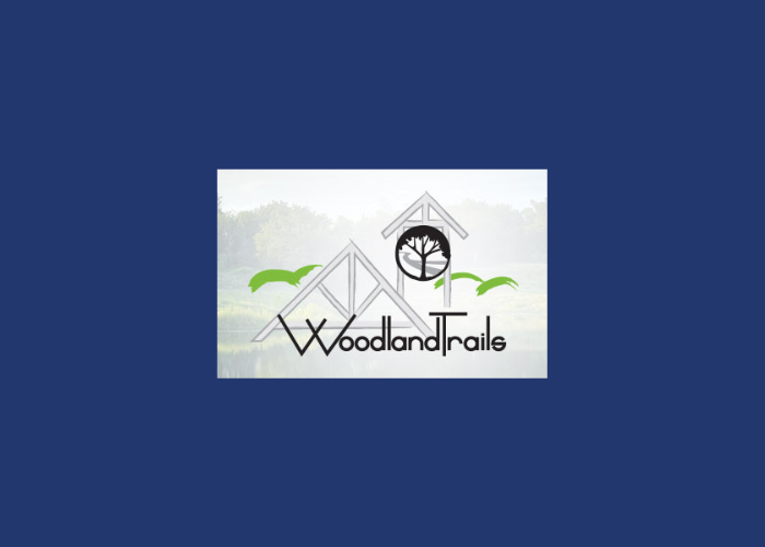 A logo for woodland trails on a blue background