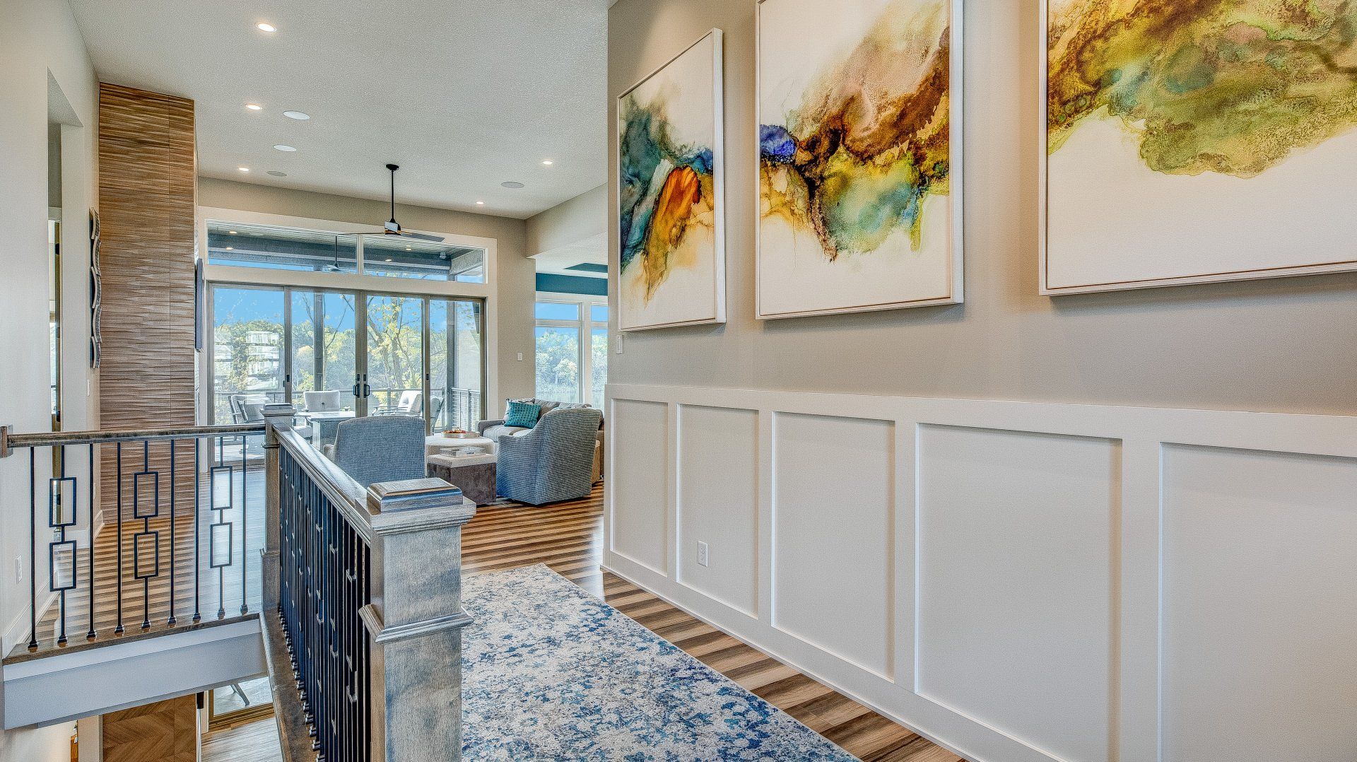A hallway in a house with paintings on the wall.