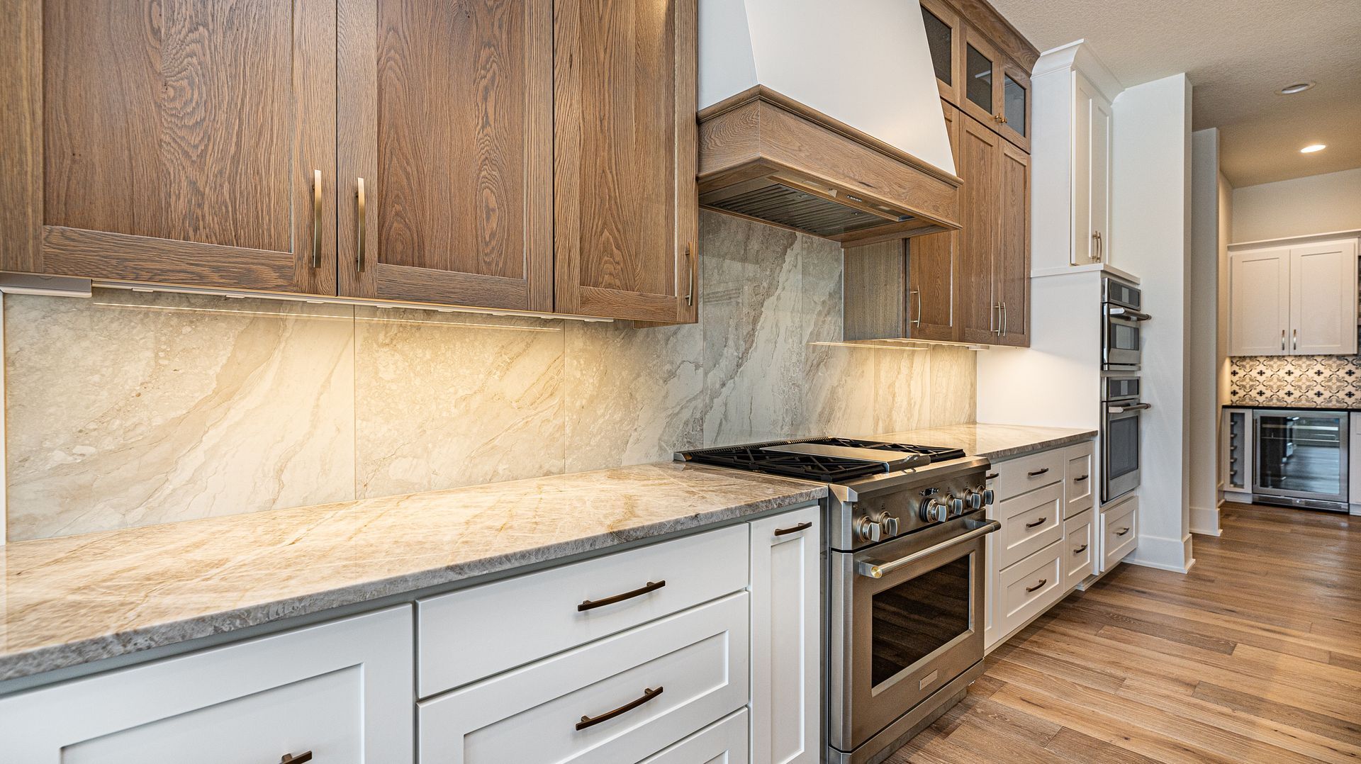 A kitchen with stainless steel appliances , granite counter tops , and wooden cabinets.