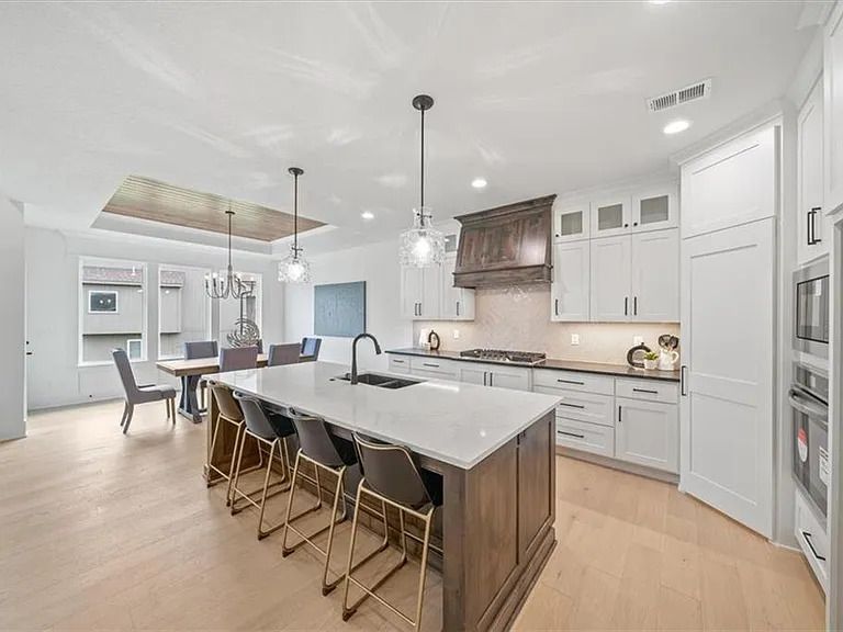 There is a large island in the middle of the kitchen.