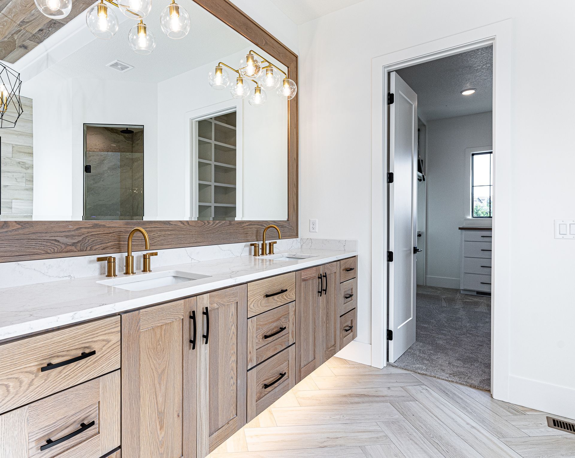 A bathroom with two sinks and a large mirror.