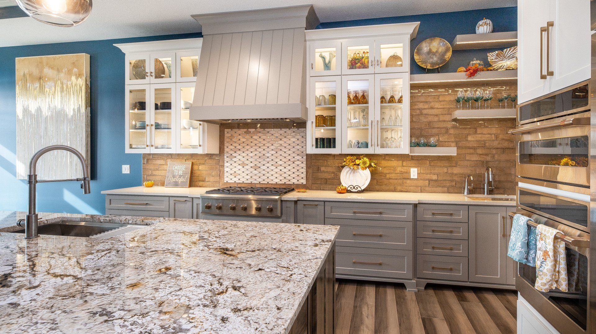 A kitchen with granite counter tops and stainless steel appliances.