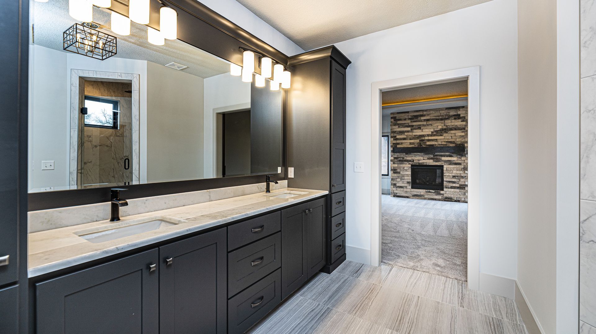 A bathroom with two sinks and a large mirror.