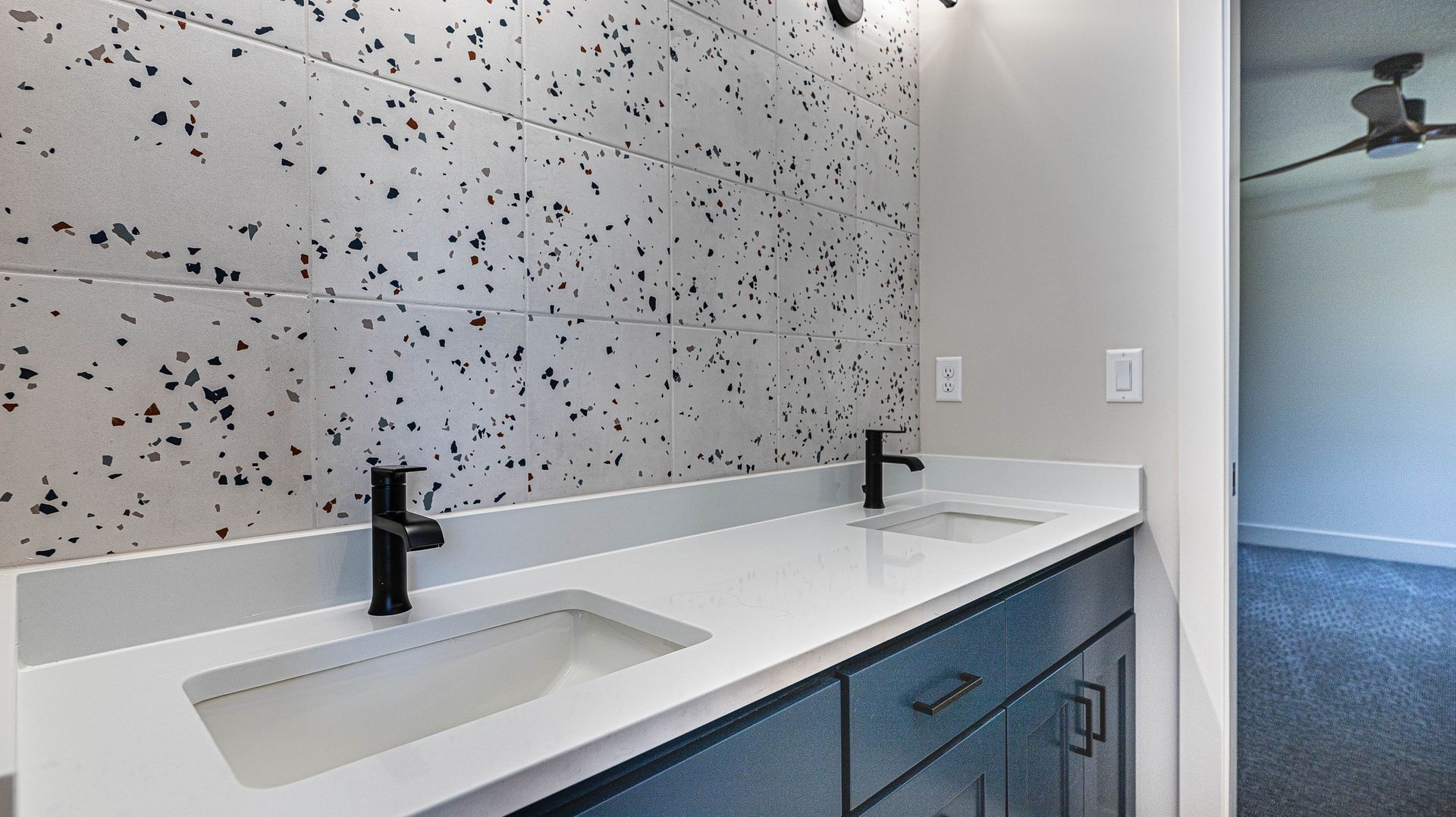 A bathroom with two sinks and a large mirror.