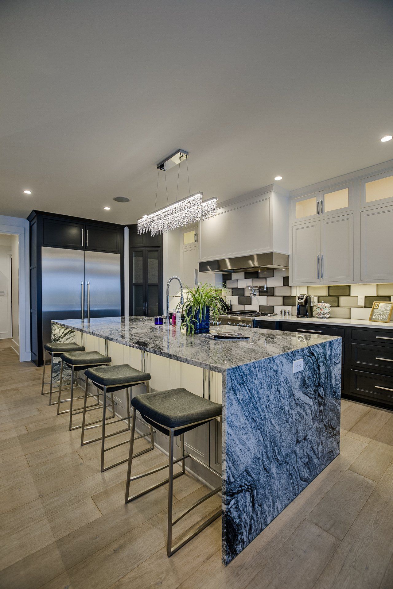 A kitchen with a large island and stools