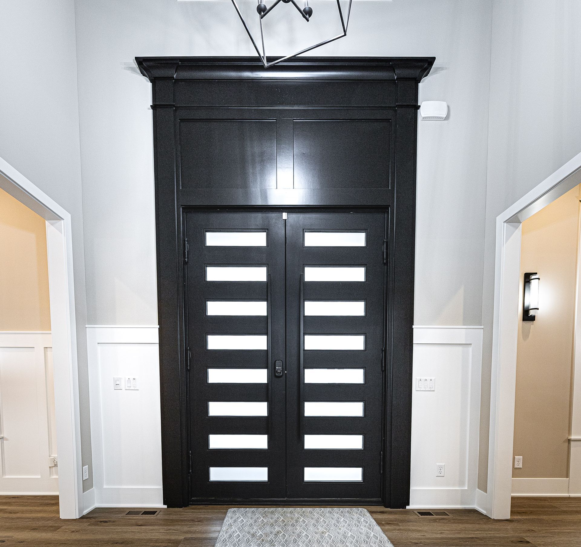 A black door with white stripes on it in a hallway