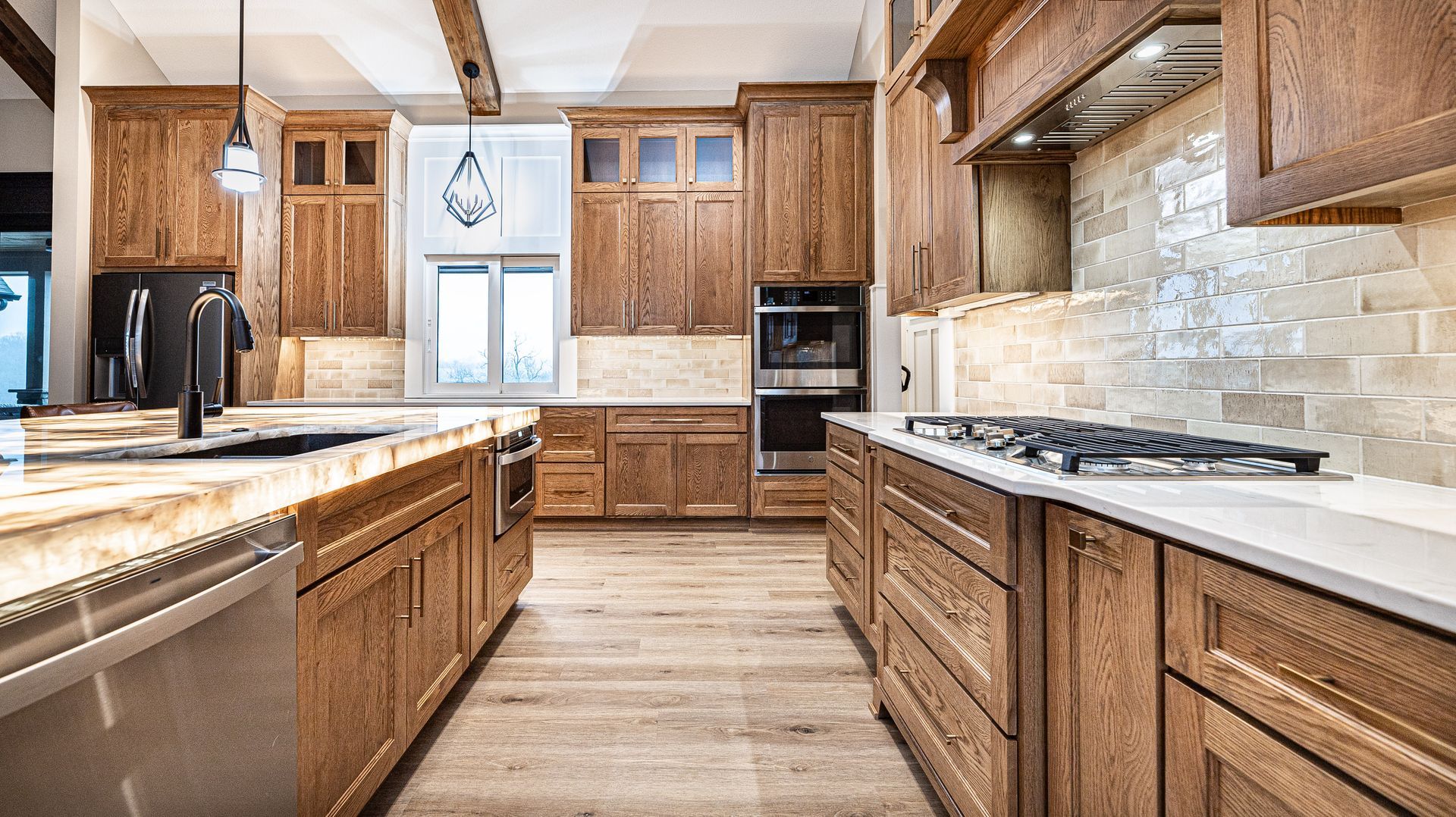 A kitchen with wooden cabinets and stainless steel appliances.