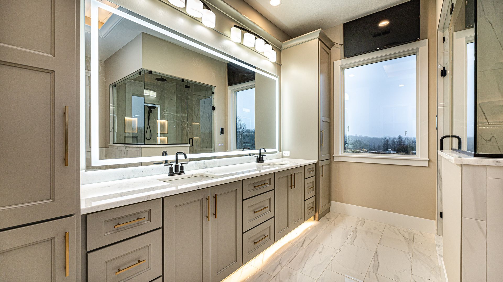A bathroom with two sinks and a large mirror.