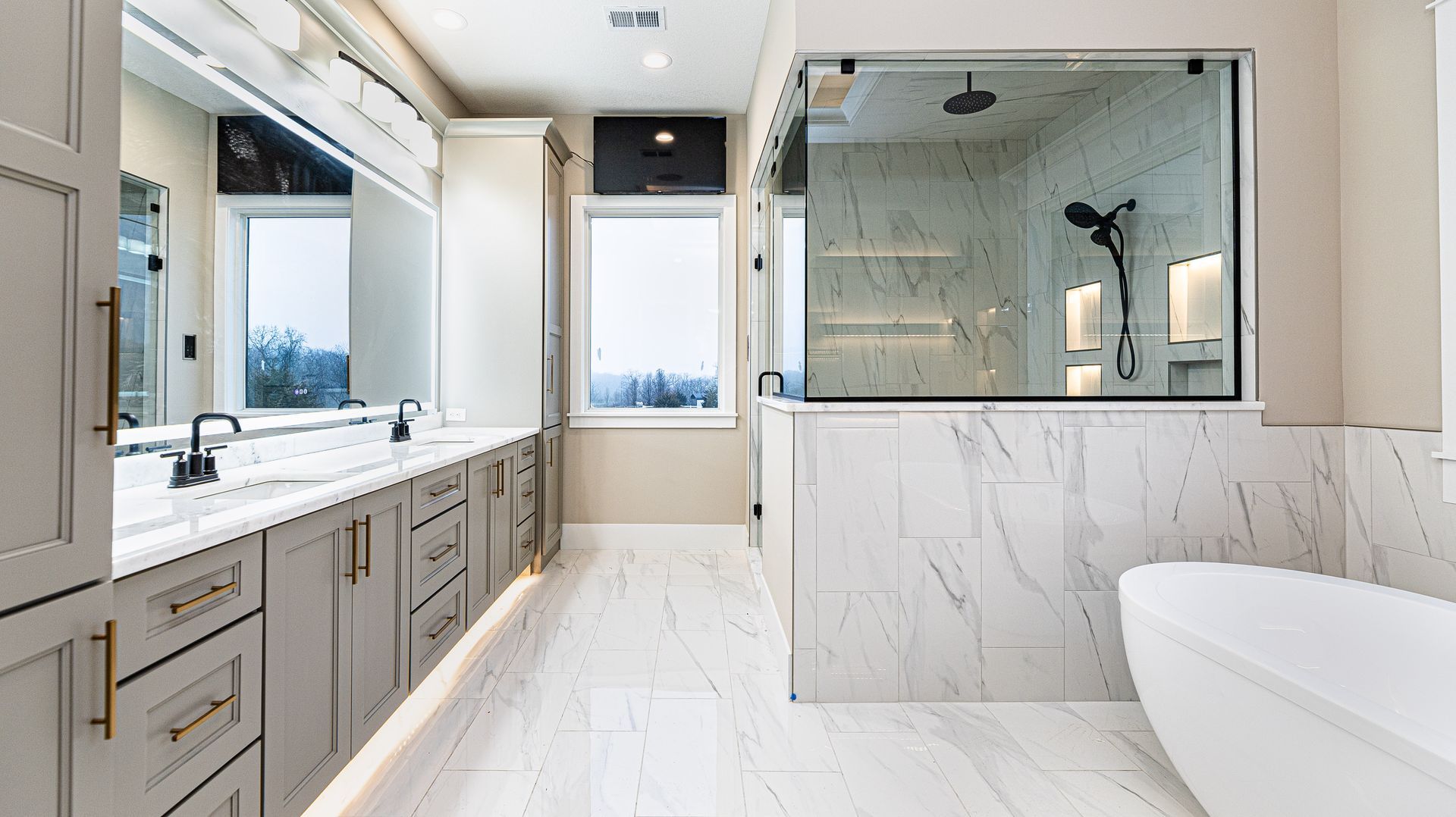 A bathroom with two sinks , a toilet , and a shower.
