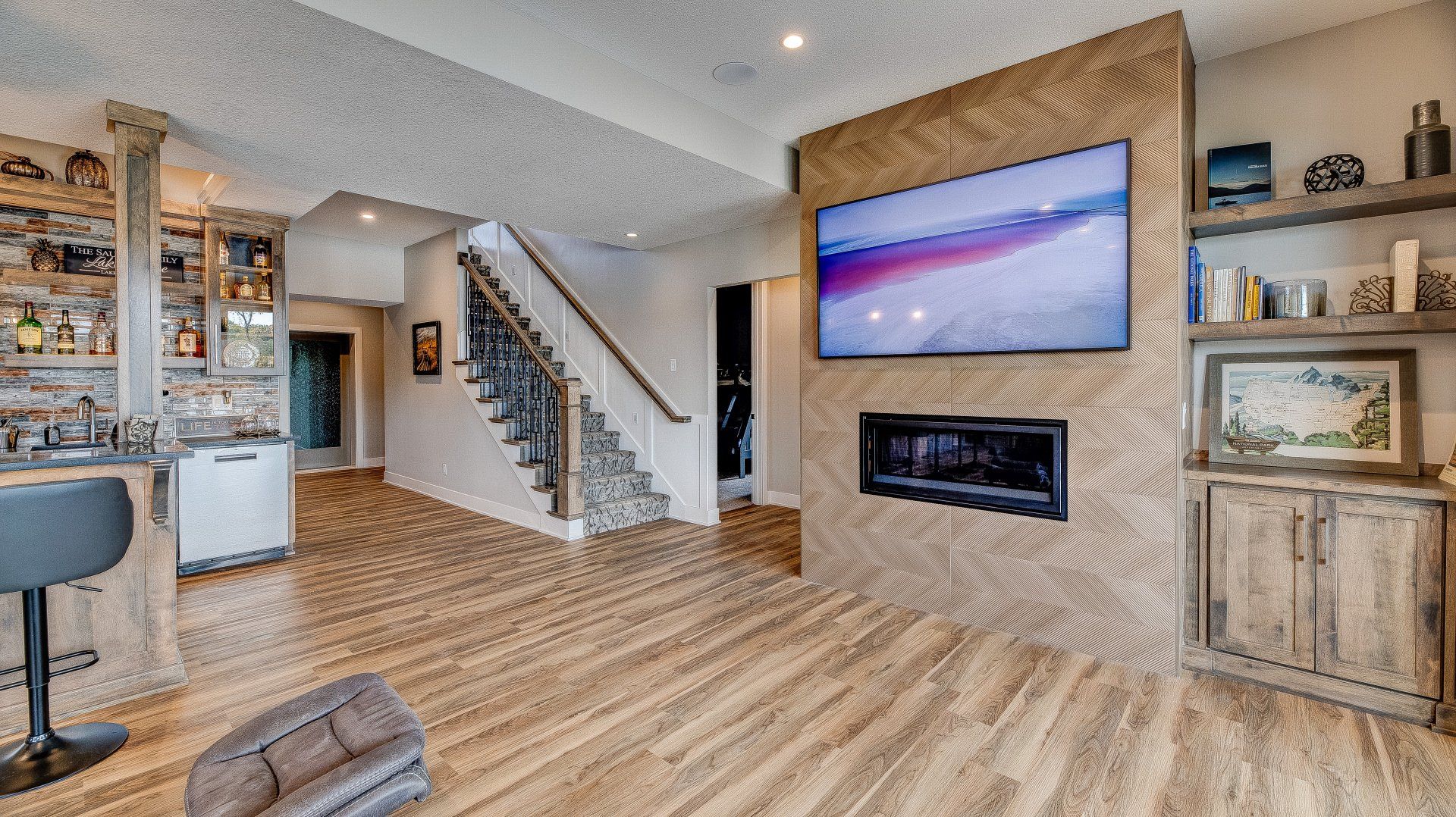 A living room with hardwood floors and a flat screen tv on the wall.