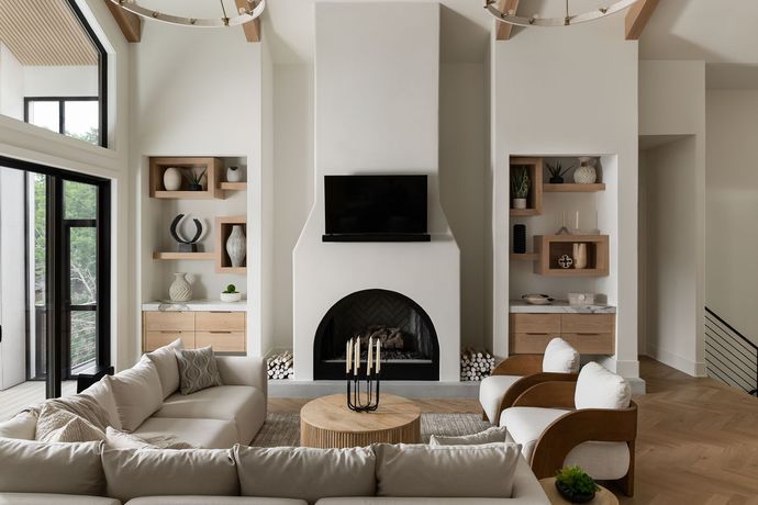 Spacious living room with white walls, fireplace, and beige sectional sofa.