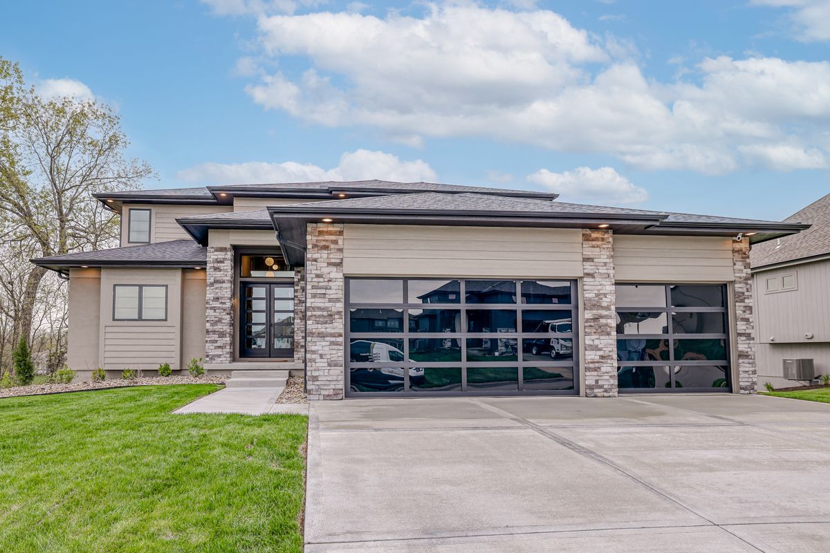 The front of a house with a large garage and a driveway.