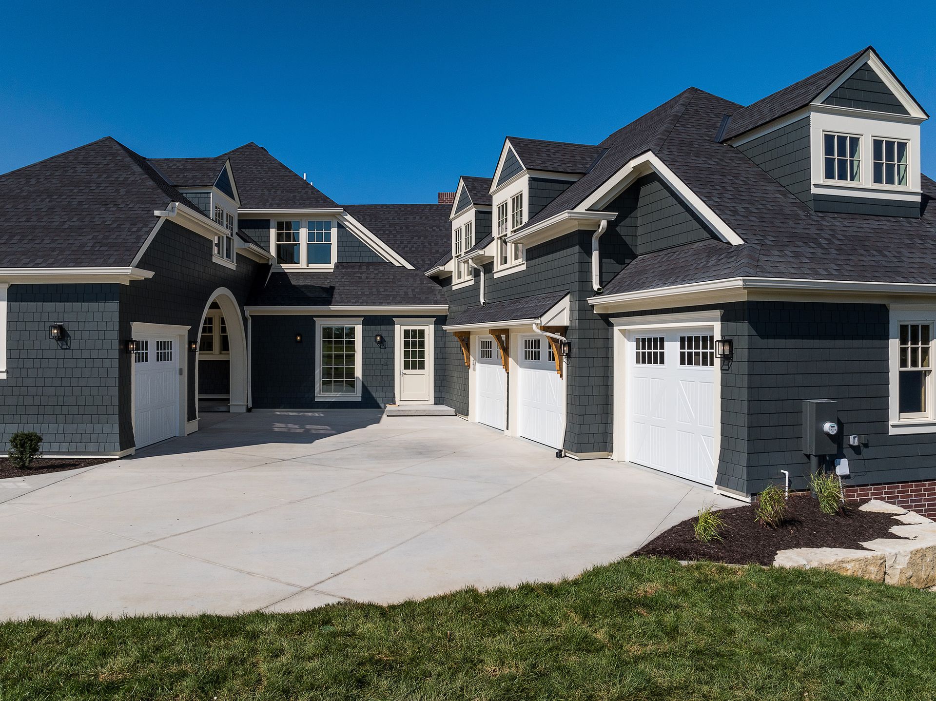 A large house with a lot of garages and a driveway