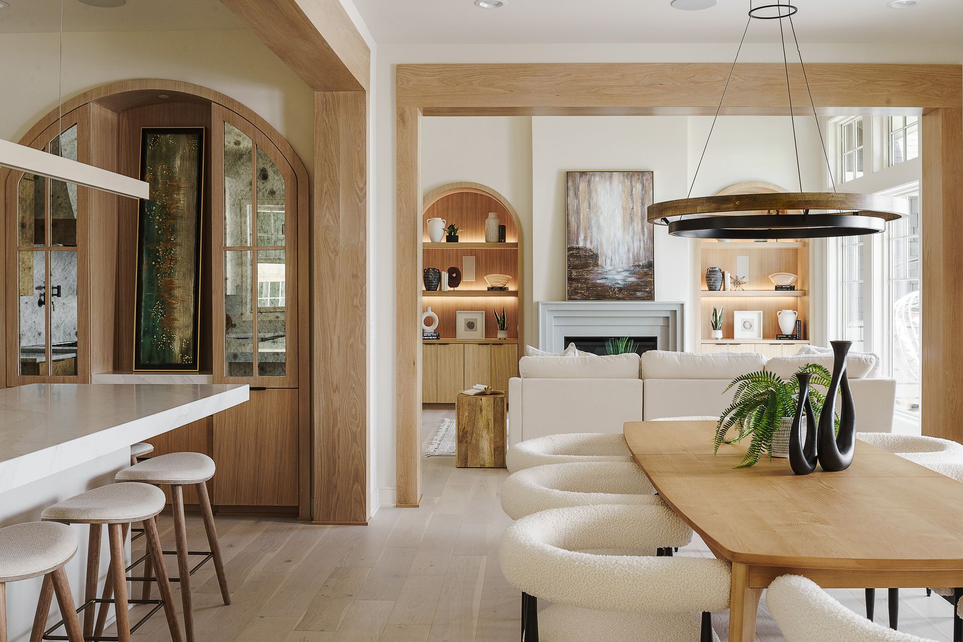A dining room with a table and chairs and a fireplace.