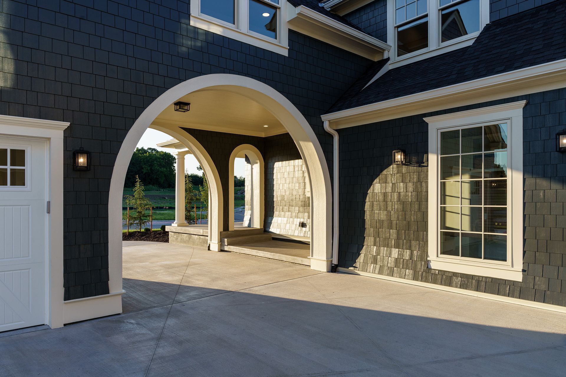 A large blue house with a white door and arches