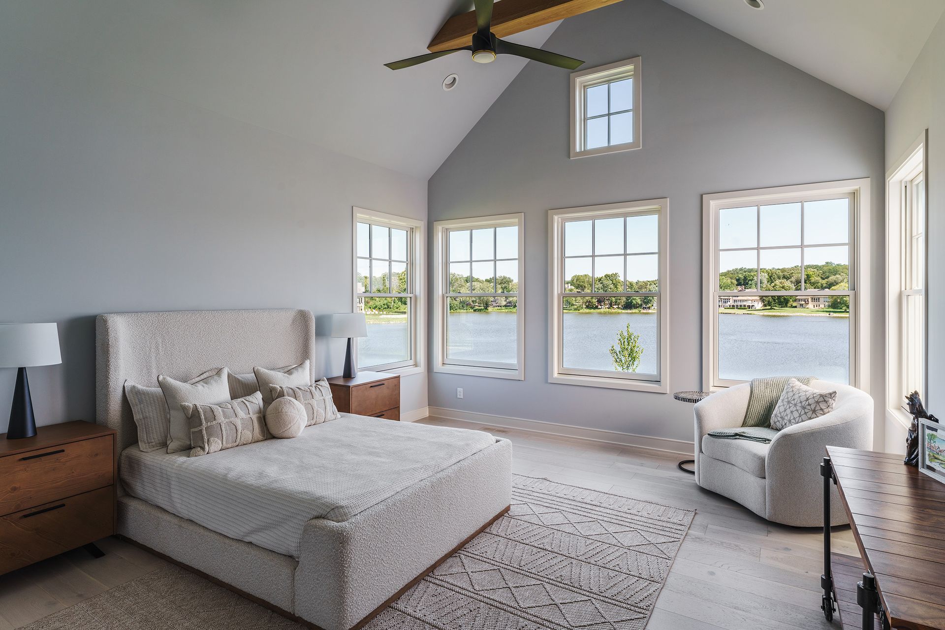 A bedroom with a vaulted ceiling and a large bed.