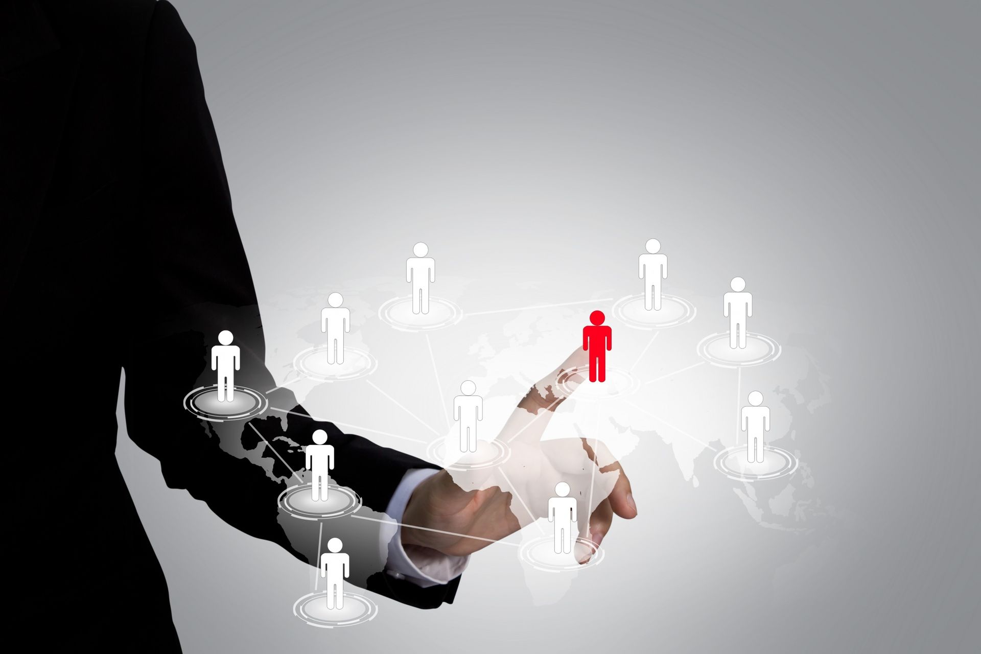 A person is holding a red person in their hand surrounded by white people.