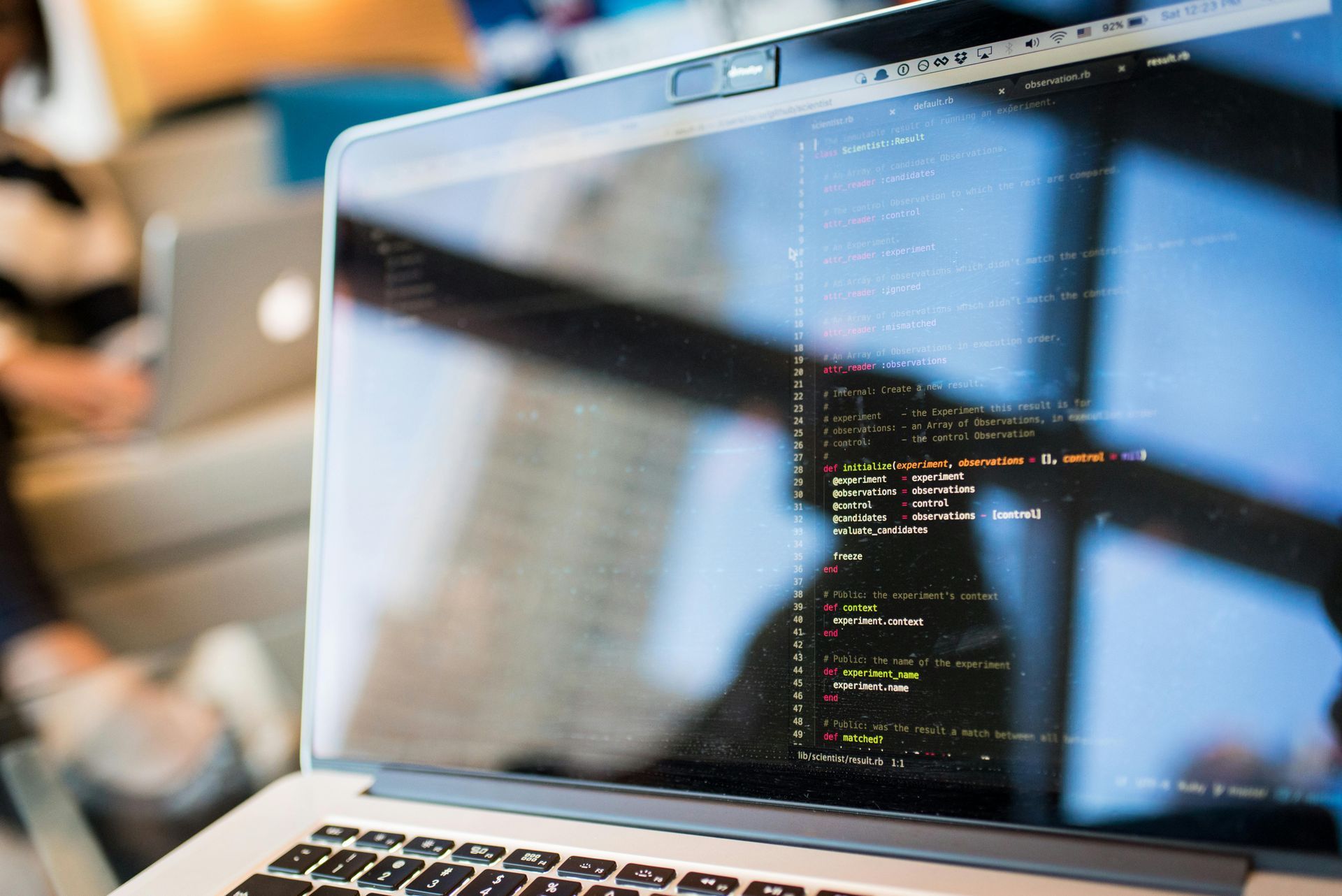 A laptop computer is open to a screen with a lot of code on it.