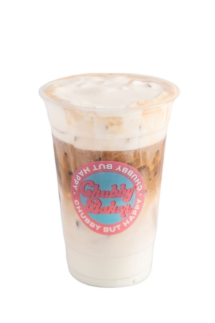 Iced coffee drink with layered cream and espresso in a clear plastic cup, featuring a 