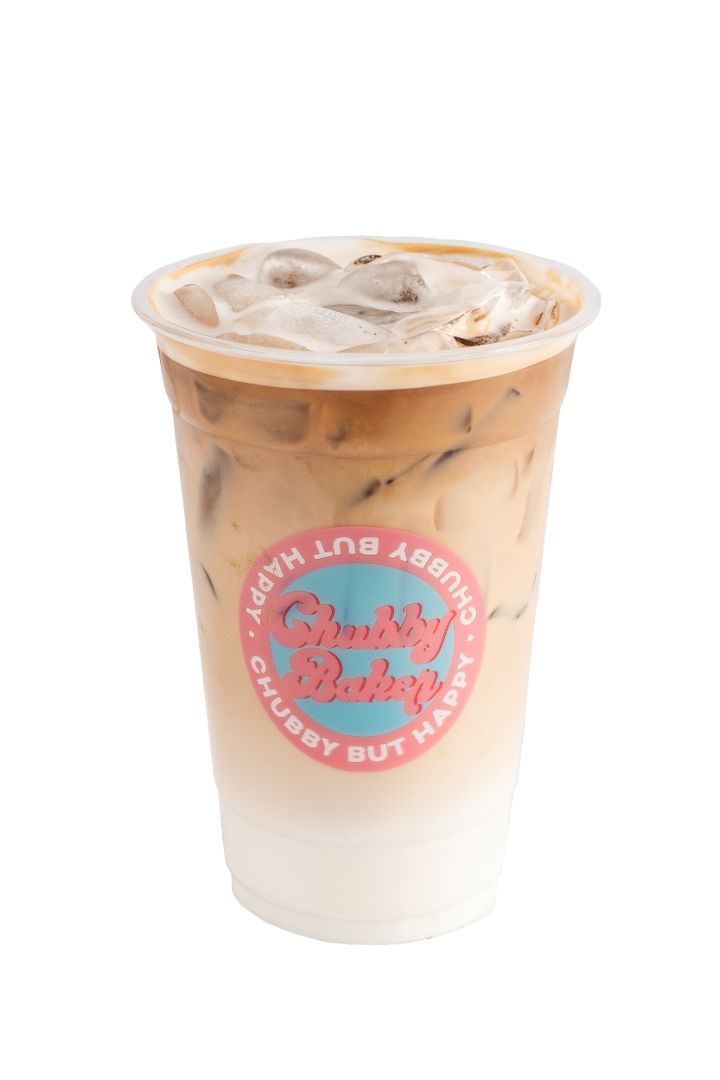 Iced coffee drink in a clear plastic cup, with a pink and blue logo that says 