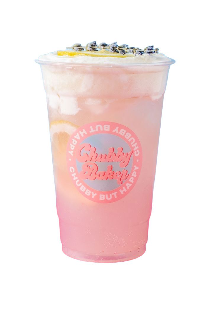 Pink drink in a clear plastic cup with foam topping and edible decorations, branded with 
