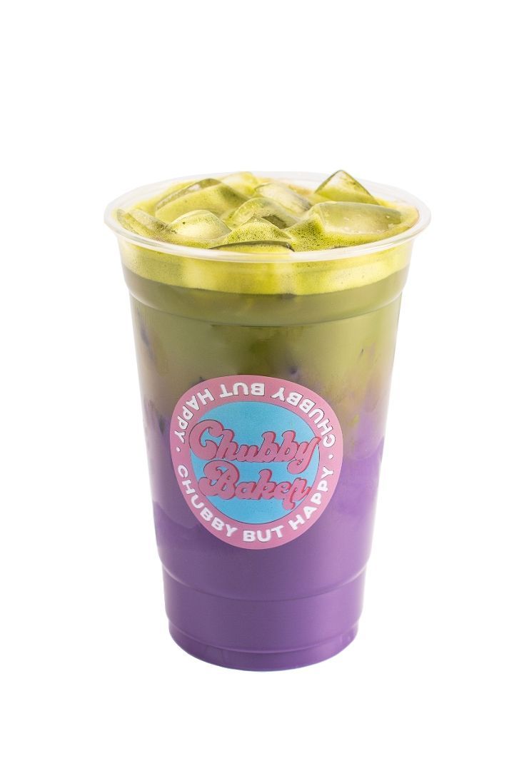 Iced matcha and purple drink layered in a plastic cup, with ice cubes on top. A pink and blue logo is on the cup.