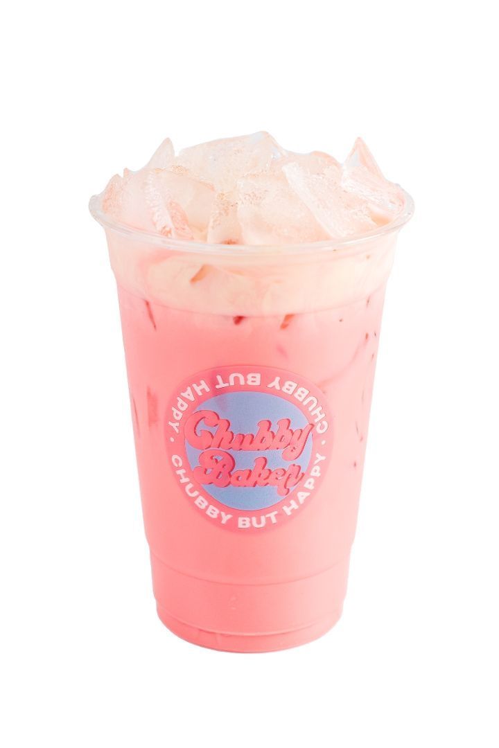 Pink drink in a clear cup, topped with whipped cream and ice. The cup has a 