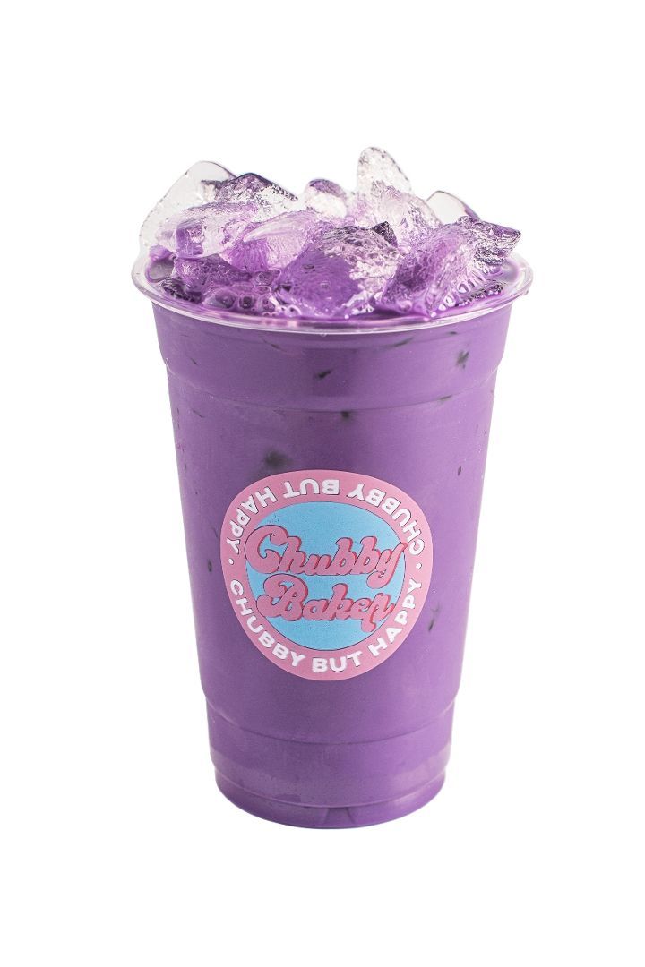 Purple ube milkshake with crushed ice topping, in a clear plastic cup with a store logo.