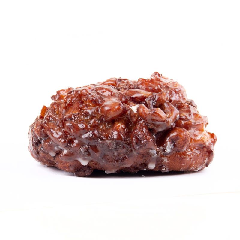 Apple fritter with a glossy glaze, against a white background.