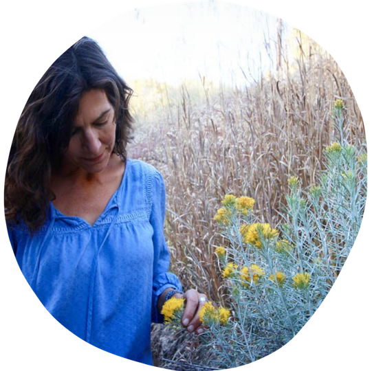 Deb Swanson is picking flowers in a field