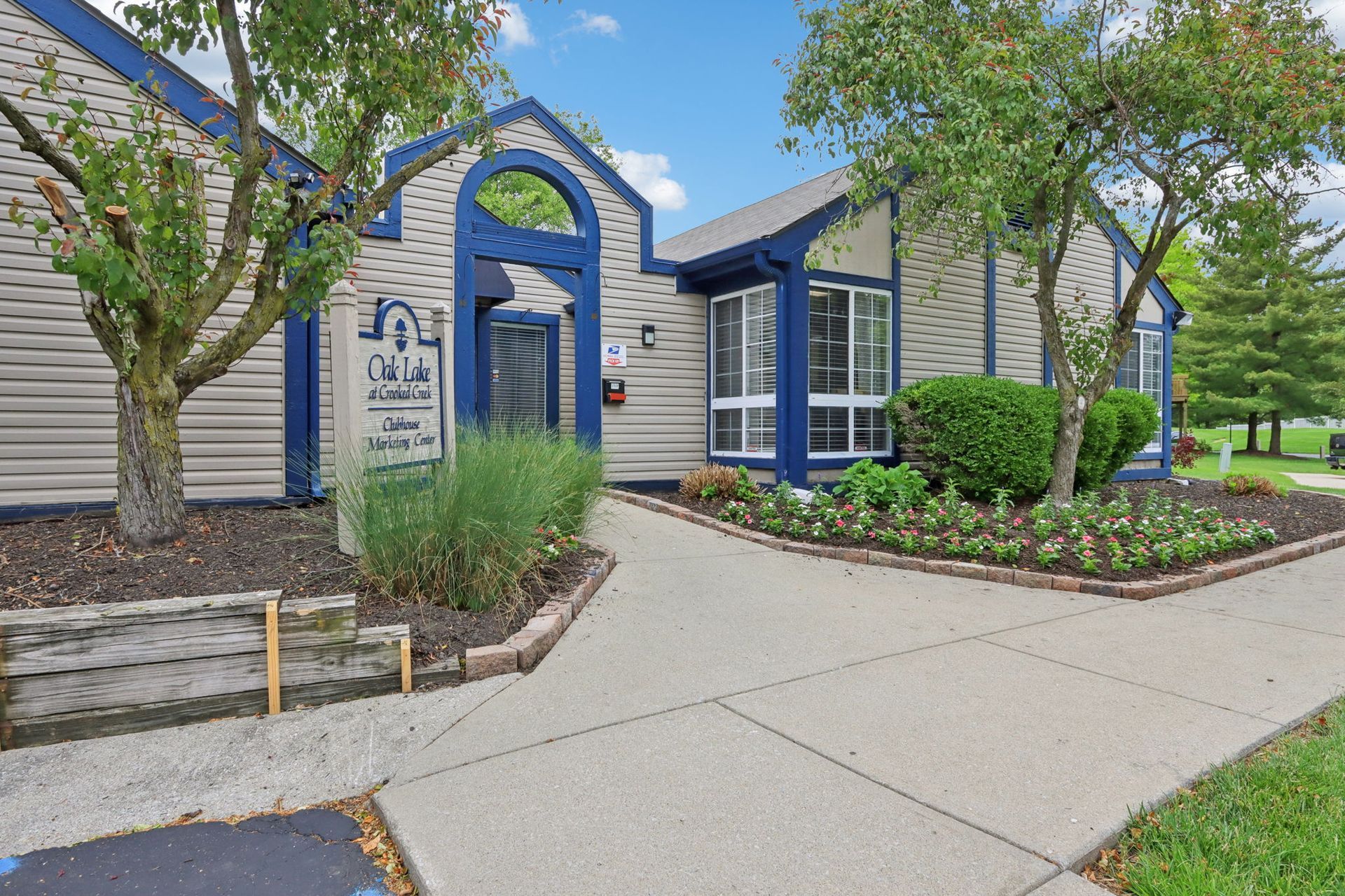 Exterior of an office building with blue trim and a walkway.