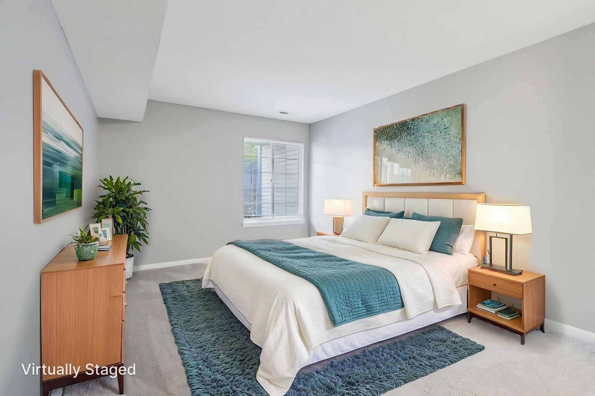 Bedroom with a bed, nightstands, dresser, rug, and artwork in shades of blue, white, and wood.