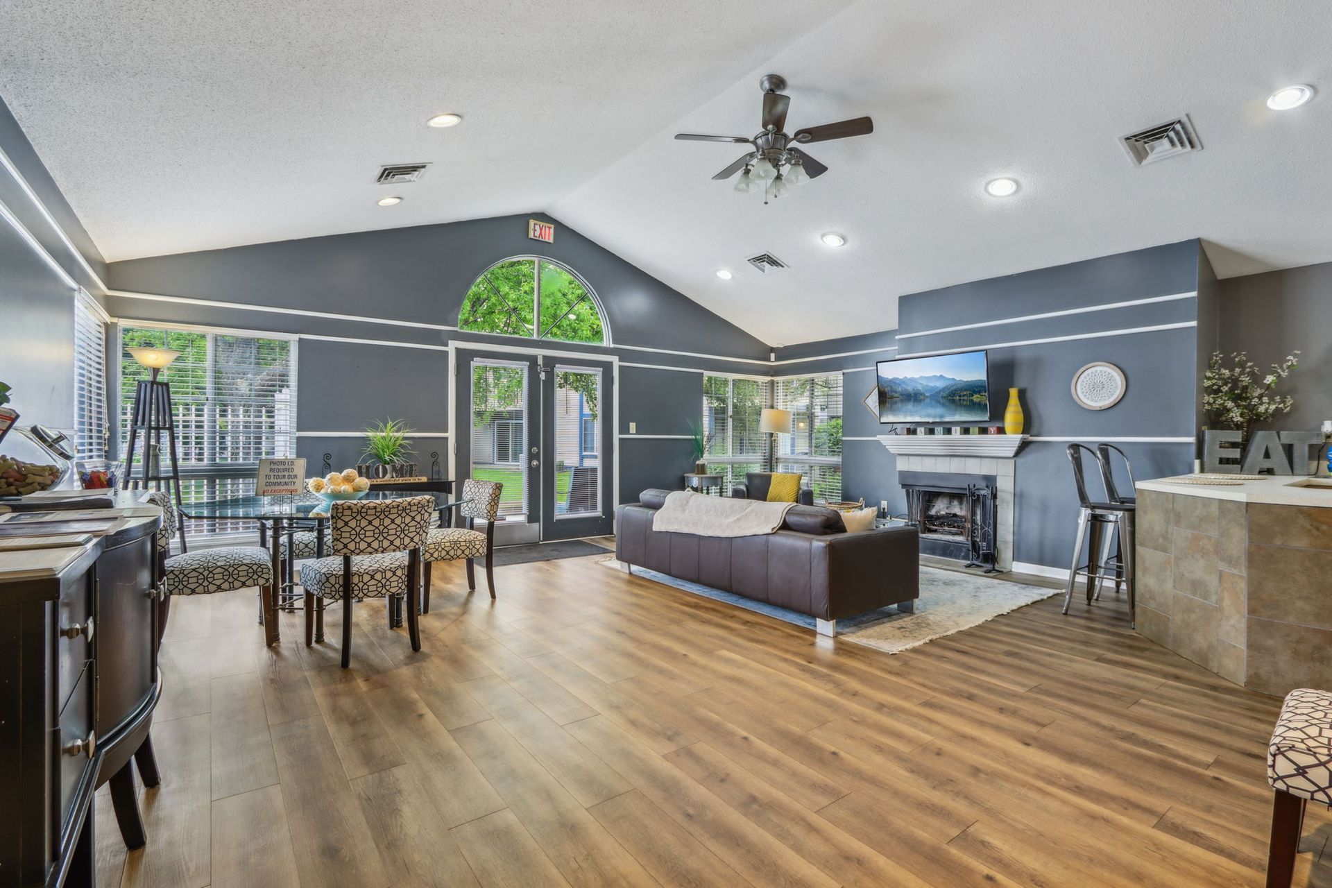 Spacious living room with fireplace, dining area, and large windows; modern design with neutral colors.