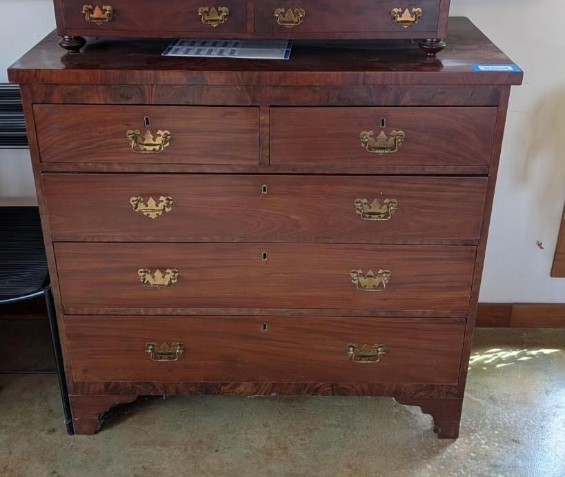 Antique wooden dresser with brass handles.