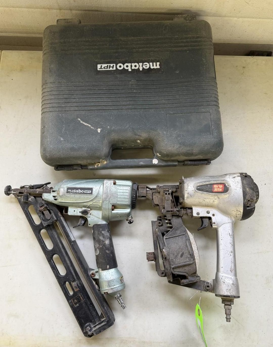 Two pneumatic nail guns and a Metabo case on a white surface.