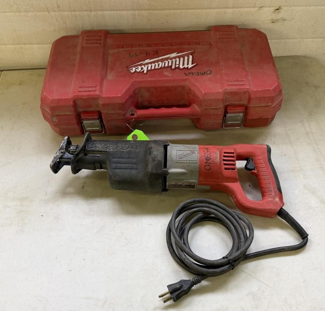 Red Milwaukee reciprocating saw with case, cord, on a white surface.