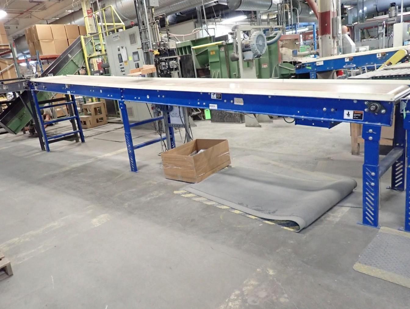 Blue industrial conveyor belt in a factory setting.