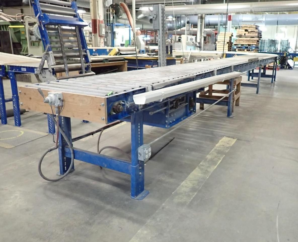 Blue industrial conveyor belt in a factory setting.