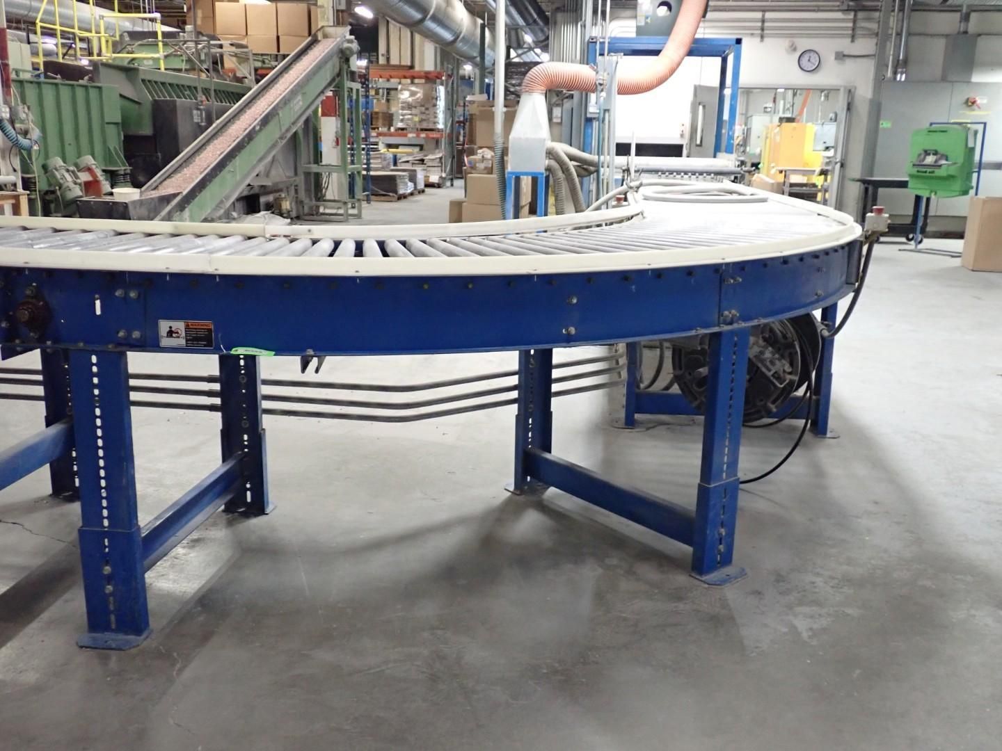 Blue conveyor belt in a factory setting.