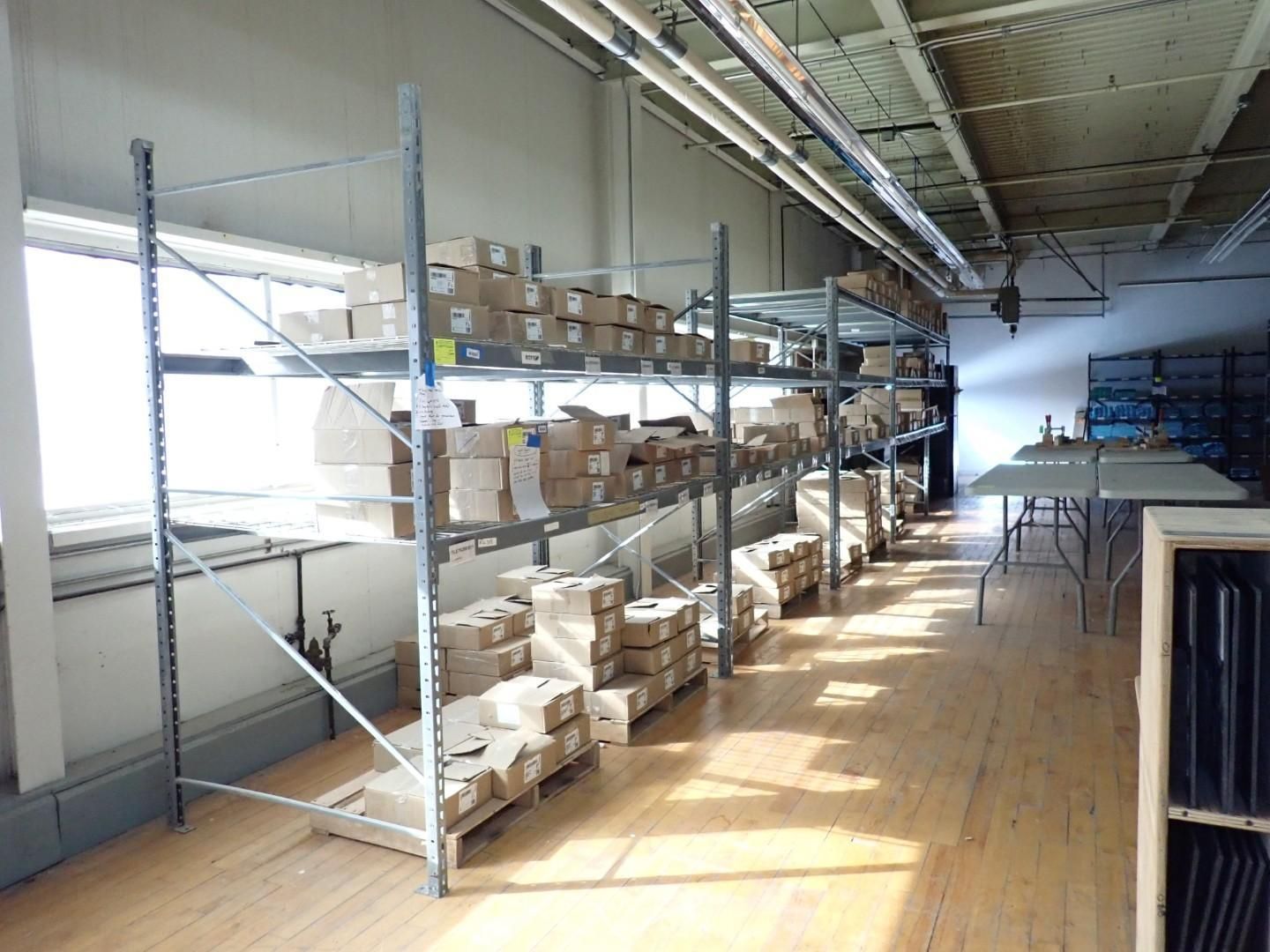 Metal shelving filled with cardboard boxes in a warehouse.