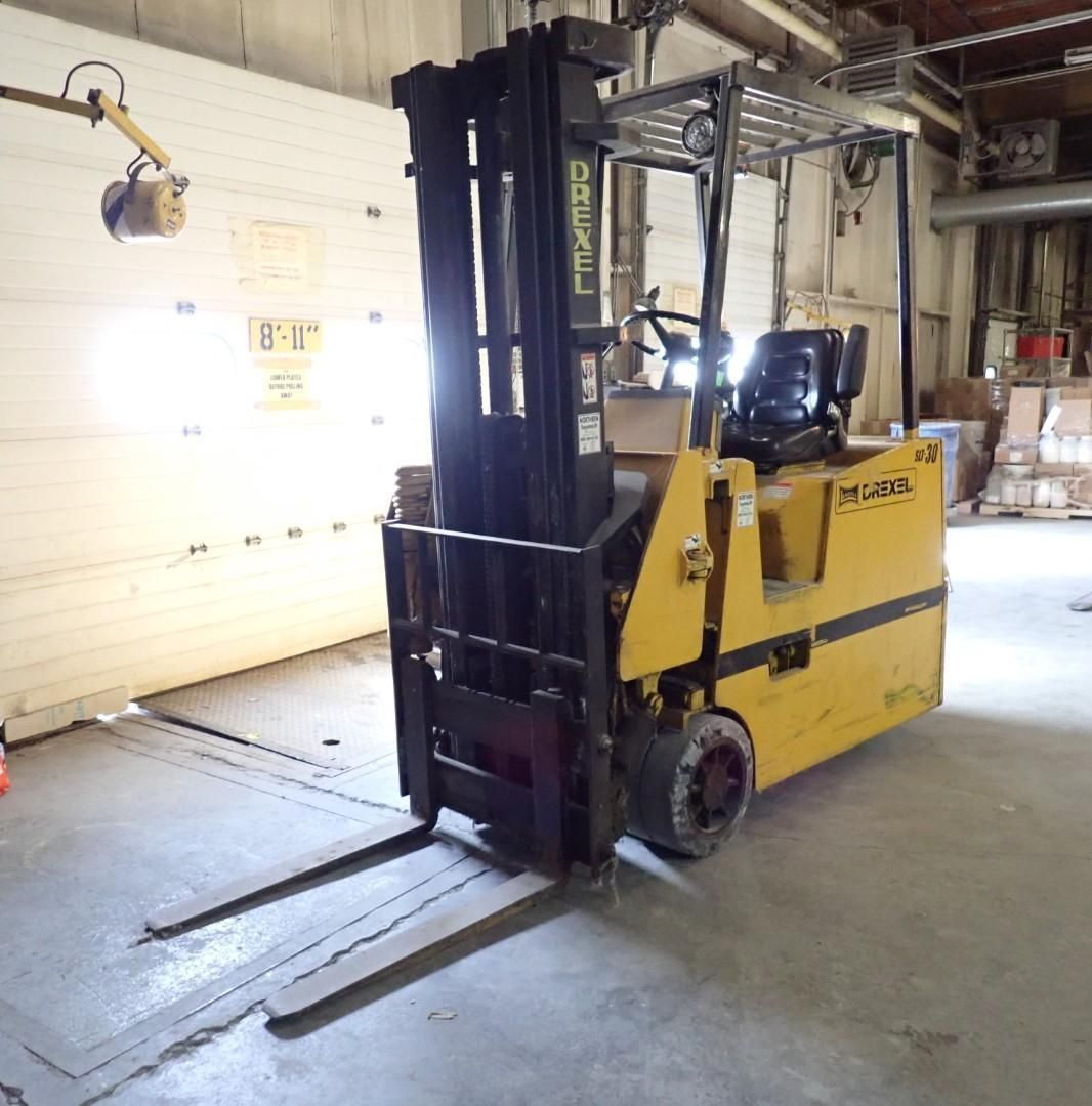 Yellow diesel forklift parked indoors, facing forward.