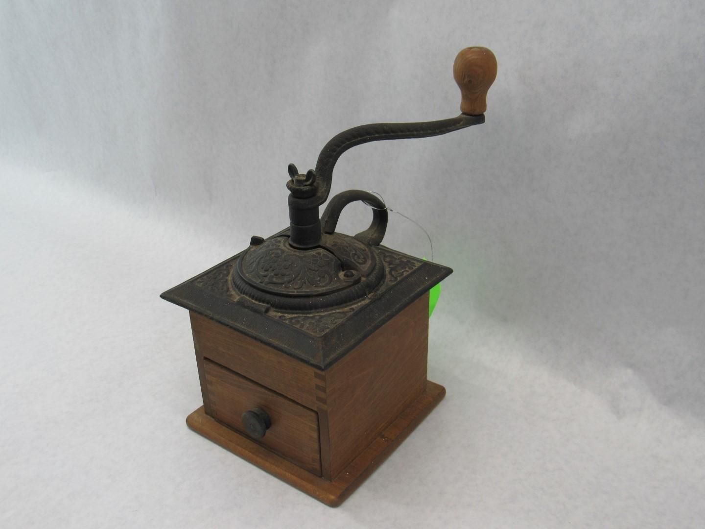Wooden and metal antique coffee grinder with crank handle.